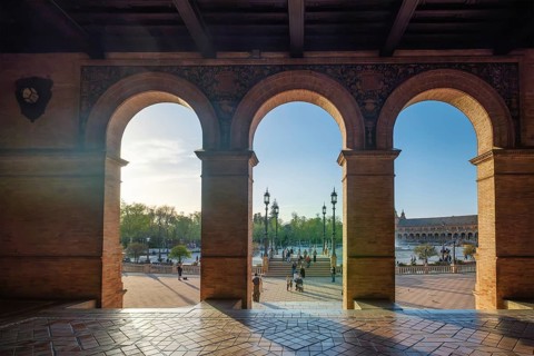 Plaza de Espana Public square in Seville, Spain with brick arch, archway, tiled floor, and canal