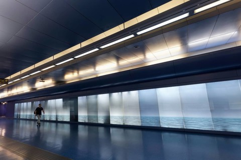 Passage in Toledo metro station, backlit wall with photo of the sea, architect Oscar Tusquets