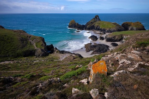 Rocks with lichens against coastal landscape, coast, rock formations, rocks, sandy beach, beach,