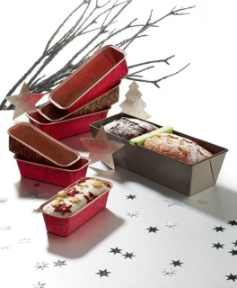 Various baking pans, branches and asterisks as decoration, against a white background, studio shot