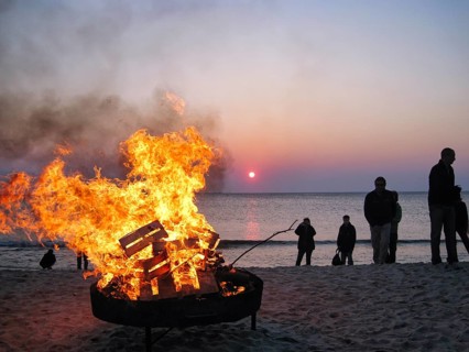 Easter bonfire, bonfire, on the beach, dark silhouettes, group of people at dusk, sunset, North