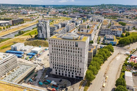 Aerial view of a modern district with high-rise buildings and surrounding green spaces, Boarding