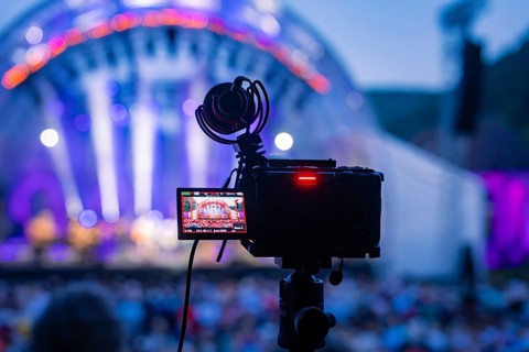 Camera films illuminated concert stage with audience, technical recording, Calwer Klostersommer