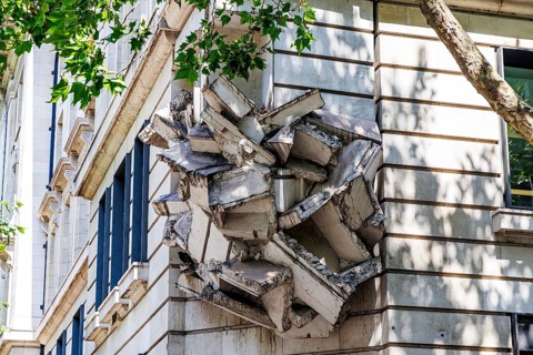 Tree branches frame Richard Wilson's Square the Block, a 2009 sculpture on the London School of