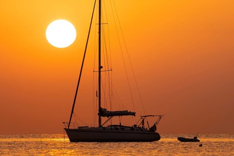 The sun rises on the horizon over the sea in Sardinia, Sardinia Italy