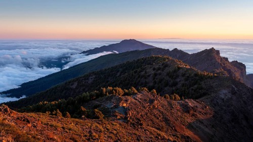 View of the south of the island on the way to Pico de La Nieve. Sea of fog in the valley at sunset.