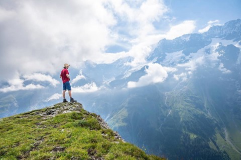 Mountaineers in front of picturesque mountain scenery at the summit of Tanzbödeli, Bernese Alps,