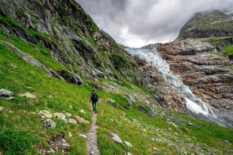 Mountaineers on a hiking trail, dramatic mountain landscape with Lower Arctic Sea glacier, Bernese