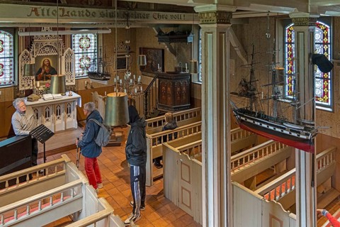Interior view, visitor, pastor, Old Island Church, Spiekeroog, East Frisia, Lower Saxony, Germany
