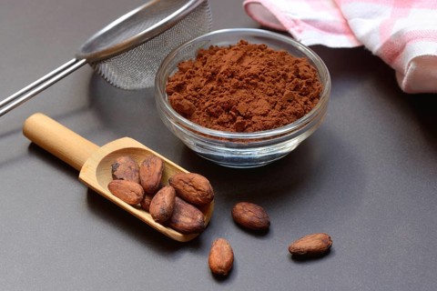 Cocoa powder in glass shell and cocoa beans