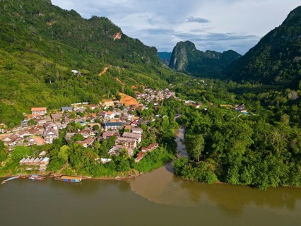 Aerial view, mountain landscape with part of the village of Nong Khiaw on the banks of the Nam Ou
