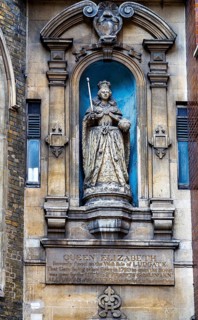A close view of the sixteenth century stone statue of Queen Elizabeth I set above the door of St