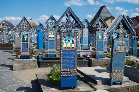 Colourful, ornate crosses of the Sapân?a cemetery in a quiet, traditional setting, traditional