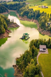 An idyllic river snakes through a green landscape full of trees, Krumbach, Vorarlberg, Austria