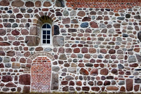 Old stone wall made of erratics rocks and bricks, Church of St. Urbanus, Dorum, Lower Saxony,
