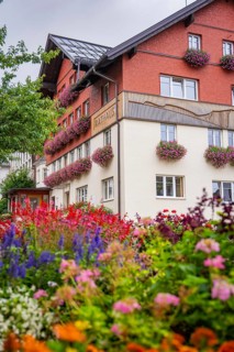 Residential building with flower-decorated balconies and a colorful front garden, Town Hall,
