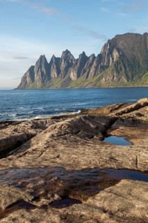 Rocky coast of Tungeneset with distinctive devil teeth in the background during summer weather in