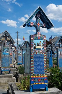 Colourful tomb with traditional patterns and ornate decorations, traditional wooden grave sites,