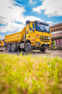 Yellow Mercedes truck on construction site under blue sky, Leonhard Weiss electrification station