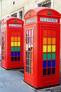 Two of the five red K2 telephone kiosks at Broad Court are seen close up, their windows fitted with