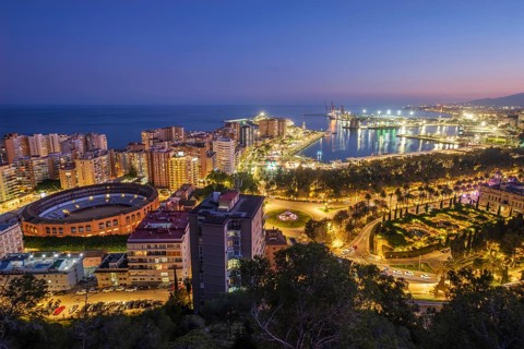 Blue hour view of Plaza de Toros de La Malagueta Bullring in Malaga, Spain, showing port of malaga,
