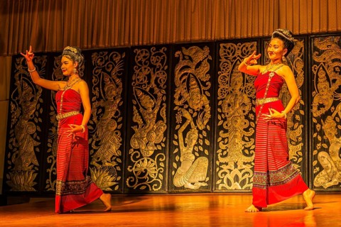 Young Thai women in traditional dress showing a traditional dance, Old Chiang Mai Cultural Center,