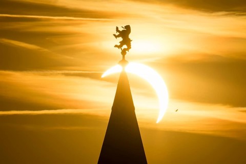 Shortly in front of sunset, the sun darkens during a solar eclipse, seen here with the Warsaw