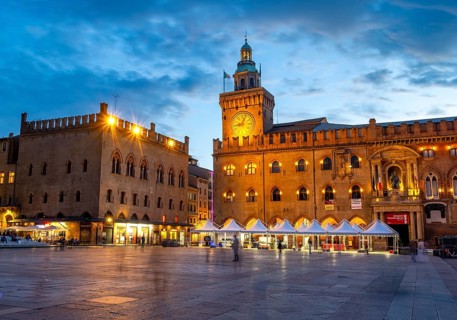 Illuminated Piazza Maggiore with Palazzo d'Accursio and Torre dell'Orologio, blue hour, old town,
