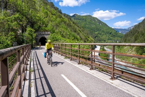 Two cyclists with panniers on a cycle path, cycle path along the old Pontebba railway line in the