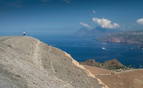 Visitor standing at the crater rim, Vulcano, in the background Lipari and Salina, Aeolian or Lipari