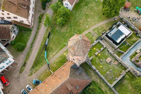 Historic tower with adjacent buildings and cars from a bird's eye view, Calwer Klostersommer
