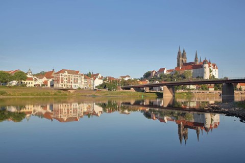 Cityscape with old town bridge, castle hill with Albrechtsburg and cathedral, reflection in the