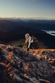 Trail running in autumn on the Jochberg on Lake Walchensee against the wonderful backdrop of the