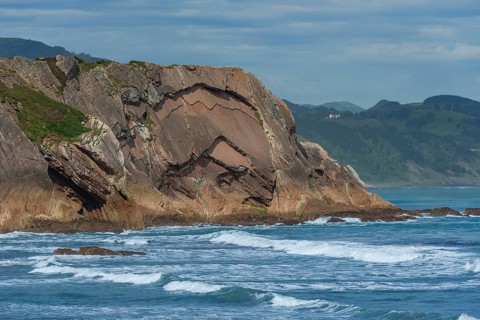 Distinctive rock cliffs as a geological formation of rock layers, Flysch on Itzurun Beach in