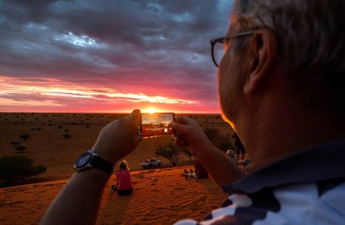 Sundowner, man, cell phone, photography, cloudy sky, desert, Kalahari, savanna, savanna with