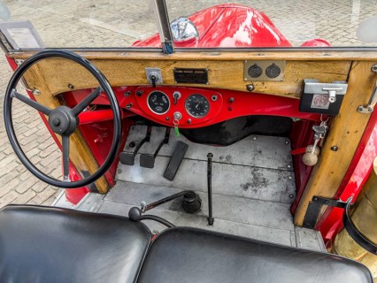 Nterior of a 1940 Volvo truck, featuring the steering wheel and dashboard. The vehicle currently