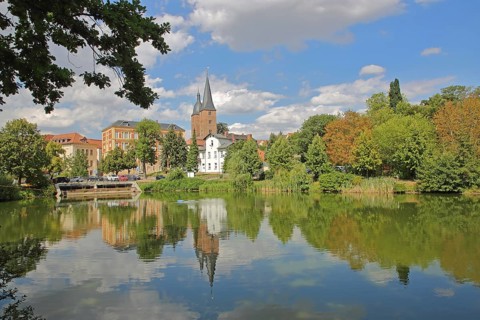 Red peaks with reflection in the small pond, landmark, double towers, cityscape, Altenburg,