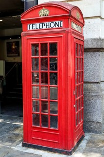 A red K2 telephone kiosk on Kingsway shows the crown motif and glazed panels of Giles Gilbert