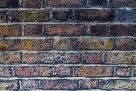 Secret London. A row of carved collar numbers along Myddelton Passage in Clerkenwell includes a