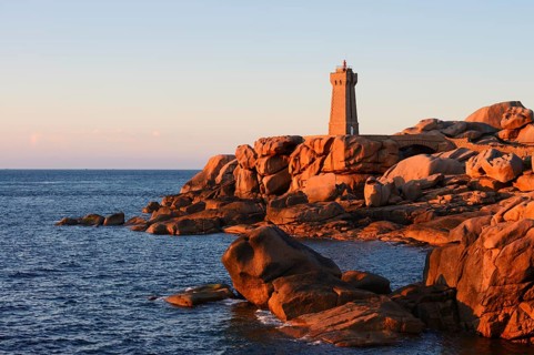 Mean Ruz lighthouse and granite rocks in the evening light, Ploumanac'h, Cote de Granit Rose,