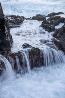 Lava rocks in the ocean, washed by waves. Charco Verde, La Palma, Canary Islands, Spain