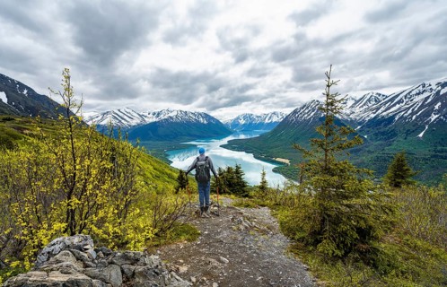 Climbers on a hiking trail, Slaughter Ridge Trail, view of snowy mountains in spring and turquoise