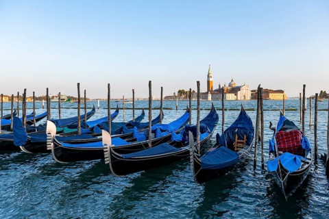 Venetian gondolas, boat launch at St. Mark's Square, San Giorgio Maggiore church in the evening