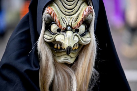 Member of a fools' guild in traditional Haes, fools' clothes, during the carnival procession in