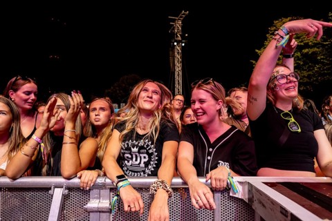 Festival visitors celebrate with the band SDP at the Superbloom Festival in Munich's Olympic Park