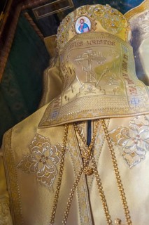 Orthodox golden crown with intricate embroidery and religious symbols, presented in a ceremonial