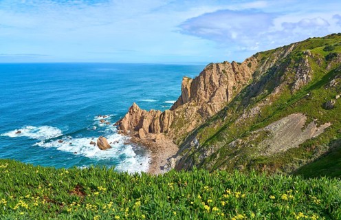At the rocky and sandy coastline of the atlantic ocean in Porto Covo, Portugal