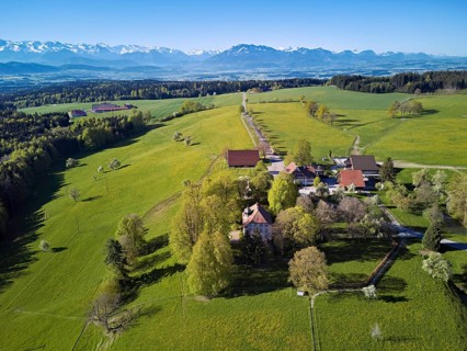 Horben viewpoint with castle and restaurant, snow-capped Alps and Mount Pilatus in the back,