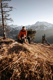 Hiker in the Allgäu at sunset in spring on the Zirmgrat near Pronten in the Allgäu