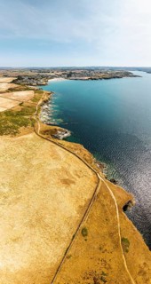 Panorama of Pentire Point and Bay over Padstow Bay from a drone, Polzeath, Cornwall, England,